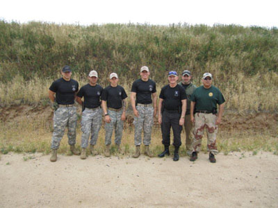 Zach Hartley (left) who led the Titan Battalion in action pistol training with SF 78.  SFA 78 Members on right.