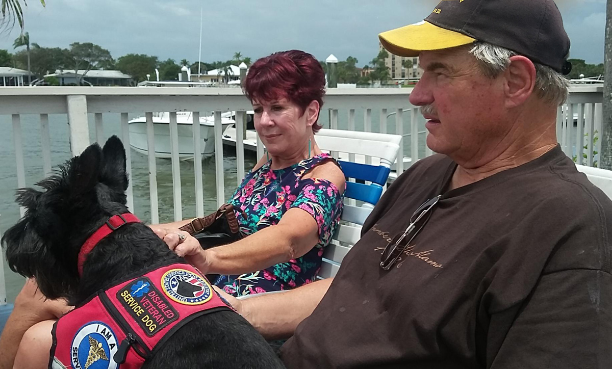 Cora and Mike relax with Sam, Berg Garlow’s service dog, on their honeymoon in May 2017. (Photo by Berg Garlow)
